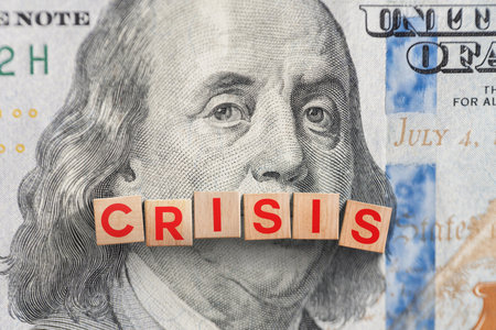Wooden cubes Crisis on 100 dollar bill, top view. Global economic crisis, concept. Economic war and import tariffs, creative ideaの写真素材