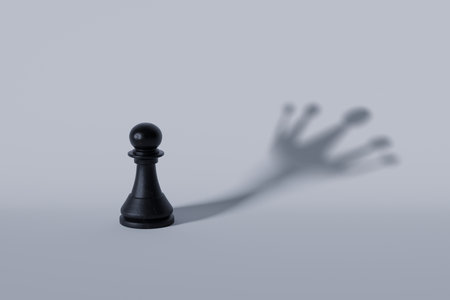 Black chess pawn with crown-shaped shadow, symbolizing ambition, growth, leadership, and potential to achieve greatness beyond humble beginnings.の写真素材