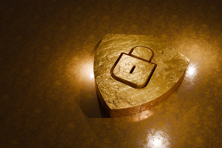Golden shield with padlock icon on textured surface symbolizing cybersecurity, data protection, and digital privacy. Elegant concept for secure technology and premium security servicesの写真素材
