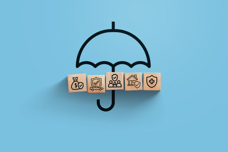 insurance, creative idea. Wooden blocks with icons of family, house, car, health and business insurance with umbrella on blue background, top view. Saving and insurance, conceptの写真素材