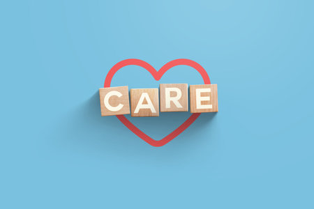 Wooden cubes with red heart on blue background. Health, insurance and pharmacy, creative idea.の写真素材