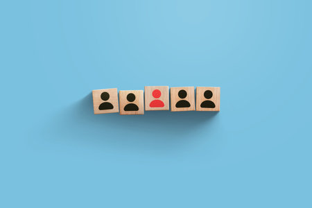 HR creative idea. Wooden cubes with staff and red leader person on blue background. Recruitment, business and team. Leadership, concept. Teamworkの写真素材