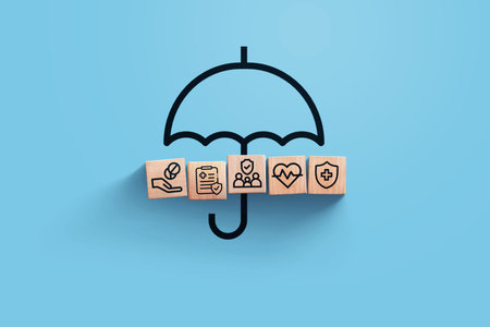 insurance, creative idea. Wooden blocks with icons of medical insurance with umbrella on blue background, top view. Health and insurance, conceptの写真素材