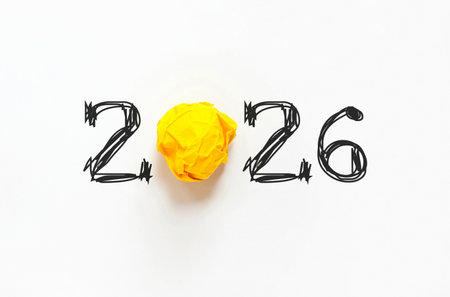 Creative 2026 text with hand-drawn black numbers and a yellow crumpled paper ball as the zero. Creative idea 2026, concept. 2026 year and crumpled yellow paper. Happy creative new year 2026の写真素材