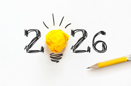 Creative 2026 concept with hand-drawn numbers and a yellow paper light bulb on white. A minimalist...