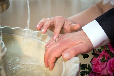 Hands pouring blessing water into bride's bands, Thai weddingの写真素材