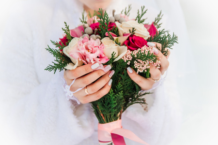 Hands and rings on the background of the costume of the groom and the bride's wedding bouquetの写真素材