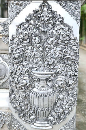 the beautiful vase of flower silver relief at the silver temple of Wat Sri Supan, Chiangmai, Thailand.の写真素材