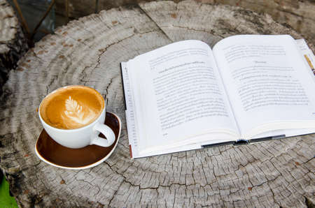 relax zone with a stump ,a book and a cup of coffeeの写真素材