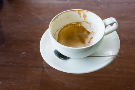 the empty cup of coffee on the tableの写真素材