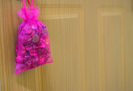 violet Scented bag haging on wood door.の写真素材