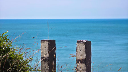 Pillars on the seashore with sea in the backgroundの写真素材