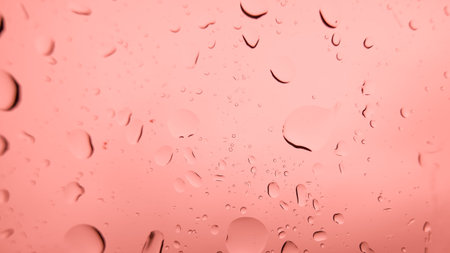 Water drops on glass with pink background, Water drops on glass.