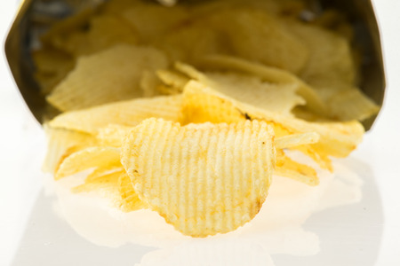 Open bag with potato chips isolate on white background.の写真素材