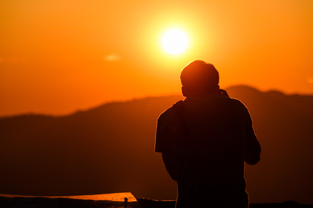 Silhouette of photographer, taking pictures of the beautiful moments during the sunset ,sunrise.の写真素材