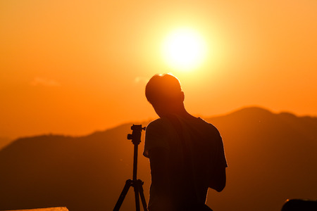 Silhouette of photographer, taking pictures of the beautiful moments during the sunset ,sunrise.の写真素材