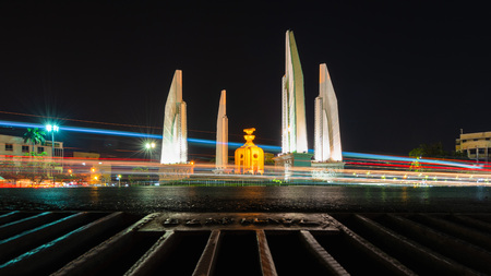 The light on the road at night and the city and democracy Monument in Bangkok, Thailandのeditorial素材