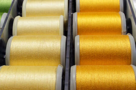 Orange sewing thread and clear yellowの写真素材