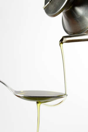 Pouring extra-virgin olive oil from a typical cruetの写真素材