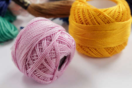 Close-up of skeins of cotton thread pink and orange