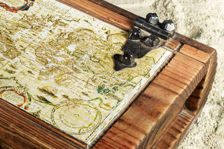 Close-up of old map in a wooden chest found on the beach