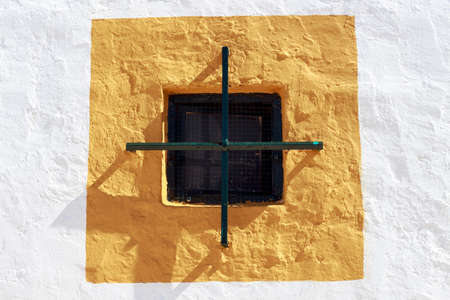 Small window on the wall of a farmhouseの写真素材