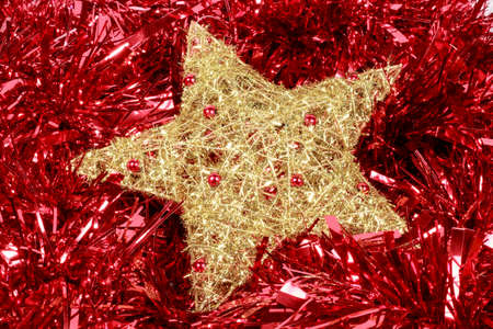 Golden star over a red garland. Christmas decoration