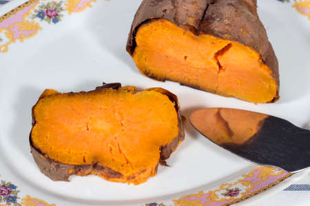 Roasted sweet potato in white ceramic trayの写真素材