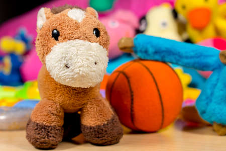 Teddy donkey posing to camera, beside blue monkey that is playing basketballの写真素材