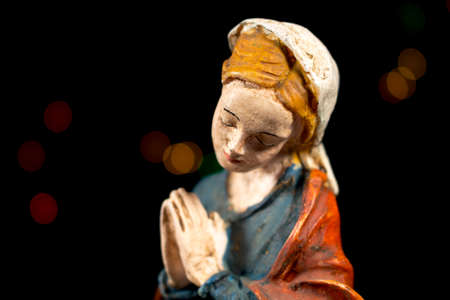 Detail of Mary Virgin with colorful stars at background. Nativity scene figures. Christmas traditions.の写真素材