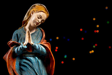 Mary Virgin with colorful stars at background. Nativity scene figures. Christmas traditions.