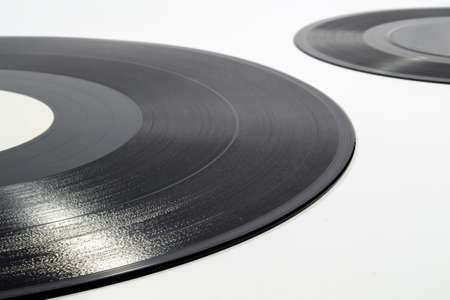 Detail of inscribed spiral groove of a vinyl record on white