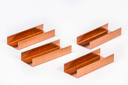 Piles of copper staples on whiteの写真素材