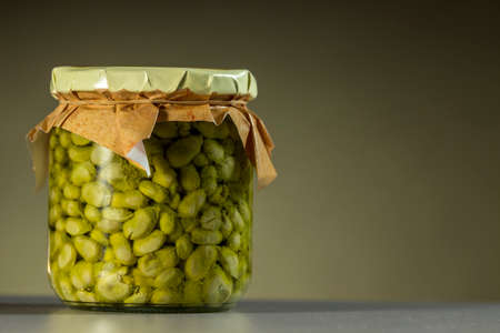 Bottle of baby broad beans, fried and conserved in Extra Virgin olive oil. Delicatessen.の写真素材