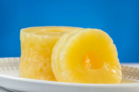 Canned pineapple slices, preserved at its own juice, on oval dishの写真素材