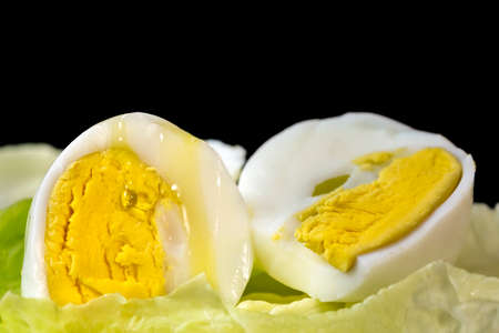Drop of Extra Virgin olive oil over the yolk of a hard boiled egg cut in halfの写真素材