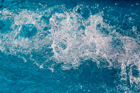 Water splash in swimming pool with blue floor. Fresh backgroundの写真素材