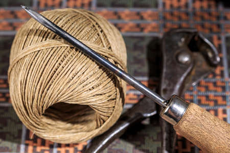 Shoemaking awl beside hemp thread and pincers, used by shoemakers an other leather workersの写真素材