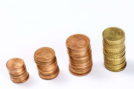 Different eurocent coins stacked in columns, on white. Blank space at top