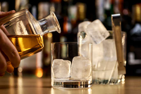 Serving a good whiskey on the rocksの写真素材
