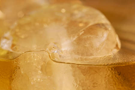 Close up of ice cubes floating in the whiskey cupの写真素材