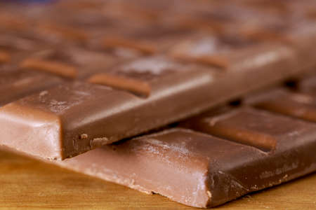 Close-up of chocolate tablets on wooden tableの写真素材