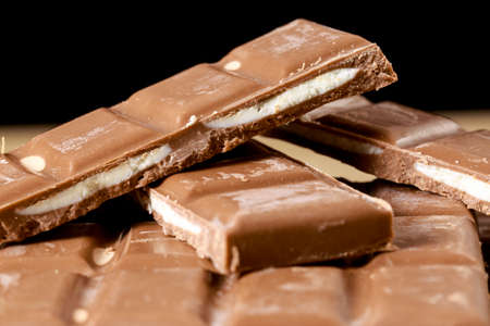 Filled chocolate bars on black backgroundの写真素材