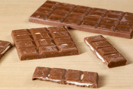 Filled chocolate bars on clear wood table
