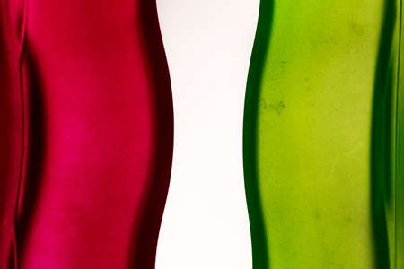 Curves in red and green glass surfaces, on white. Primary colors backgroundの写真素材
