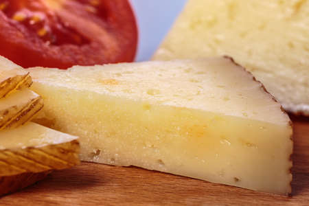 Tapa of Manchego cheese with fresh tomato slices