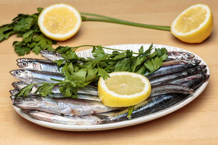 Mediterranean anchovies with parsley and lemon. Cooking Mediterranean food