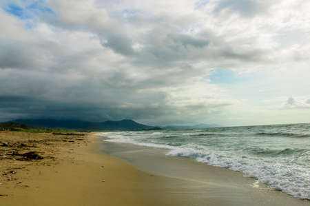 Waves coming from the sea, hitting the beachの写真素材