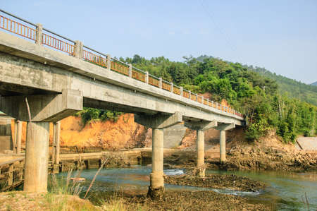A bridge across a river in the mountain sideの写真素材