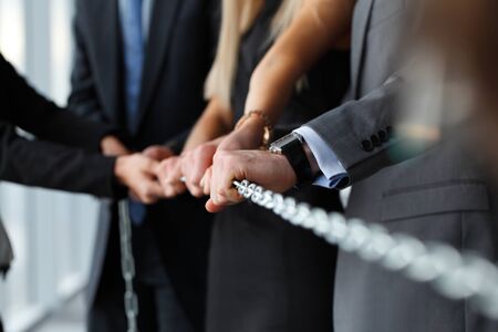 team pulling steel chain togetherの写真素材